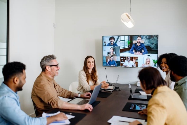 A hybrid training session with people in the room and remote attendees on screen